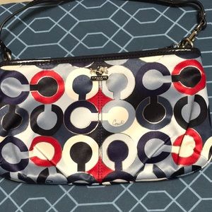 Coach multi color wristlet, satin inside and outside. Leather strap